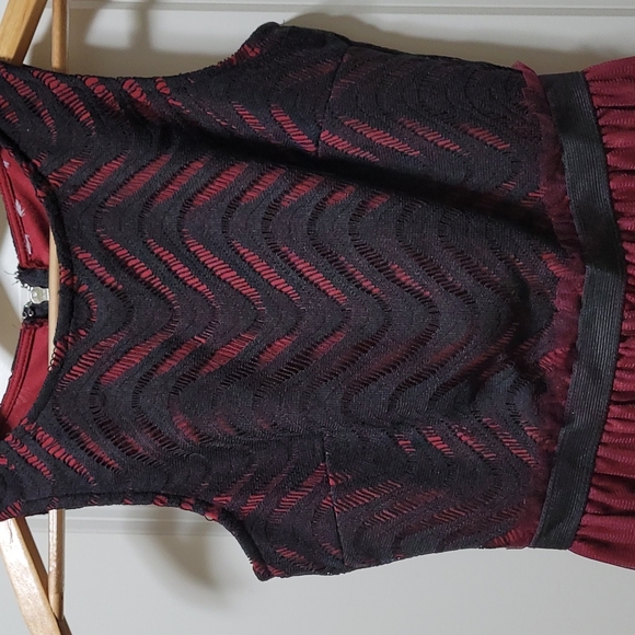 Burgundy dress with black design on the top art of the dress. Size Small - Picture 2 of 9